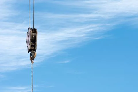 A hook of a crane with a blue sky as a background Stock Photos