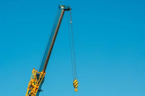 The hook of a crane without a load on the background of blue sky Stock Photos