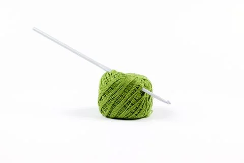 The hook is inserted into a ball of green thread. Knitting. Isolate on a white Stock Photos