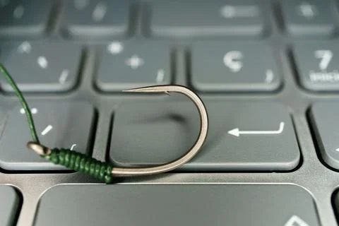 Hook on the keyboard of a computer phising concept Stock Photos