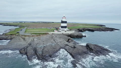 Hook Lighthouse Orbit Drone Shot on Irish Coast Wexford Vídeos de archivo 333352061