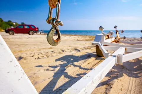 Hook for loading the boat on the trailer placed on the sandy beach Stock Photos