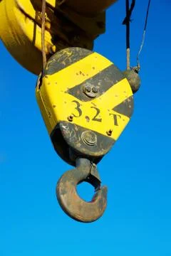 Hook of the old crane in the blue sky Stock Photos