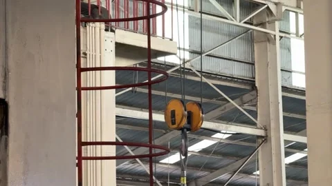 Hook of overhead crane inside a production line. Stock Footage 338192344