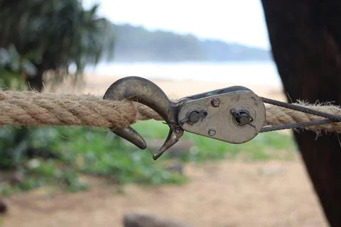 Hook on rope tied around tree by the beach, tensile rope between trees Stock Photos