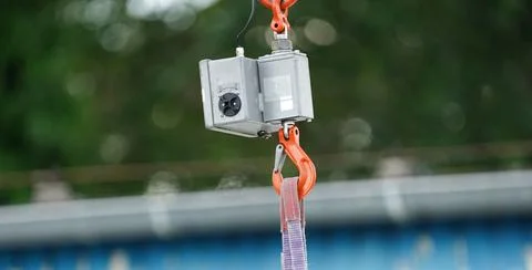Hook scale hung on a crane's hook. Weighing in the air. Weight. Stock Photos