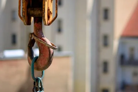 Hook of a tower construction crane in the background of urban development. Stock Photos