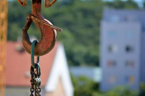 Hook of a tower construction crane on the background of the old city building. Stock Photos