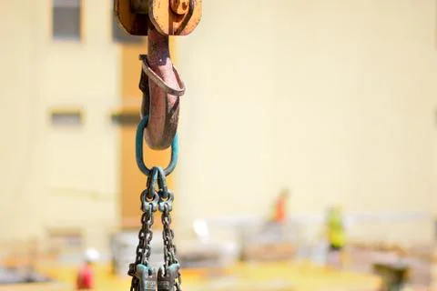 Hook of a tower construction crane on a background of a construction site. Stock Photos