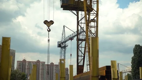 Hook of tower crane with chains hangs at construction site Stock Footage 113395374