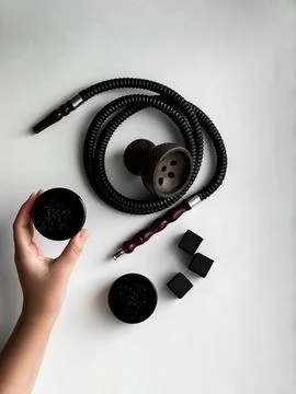 Hookah accessories set flat lay on white background wish bowl, hose and charcoal Stock Photos