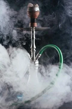 Hookah on a black background with smoke Stock Photos