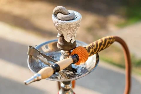 Hookah on blurred background. Cup for hookah stretched with foil and smoking  Stock Photos