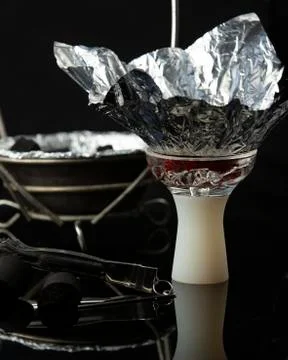 Hookah bowl with clipper in dark background Stock Photos