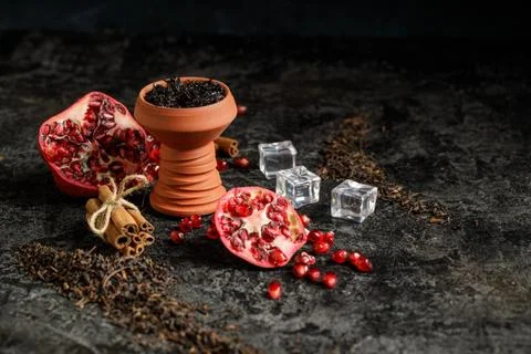 Hookah ceramic head fulled with aromated molose, pomegranade, blueberry and ice Stock Photos