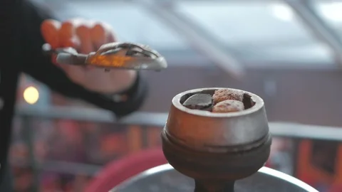 Hookah close-up. A man's hand puts coal in a hookah. Stock Footage 95557214