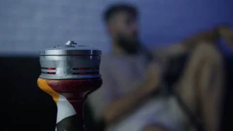 Hookah cloud against which a man sits and exhales smoke Stock Footage 204843415