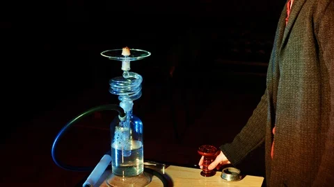 Hookah master prepares hookah. Puts bowl on top of hookah 動画素材 95576151