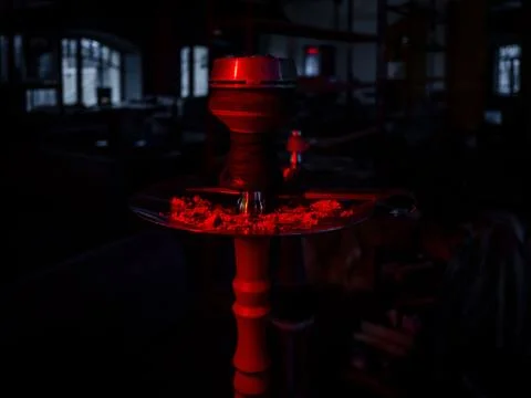 Hookah in red lighting in a cafe. Eastern traditions Stock-Fotos