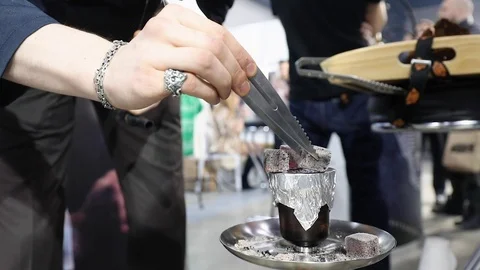 Hookah Server Using Tongs To Puts A Hot Coal On The Clay Bowl, Covered With Foil Stock-Footage 104748287