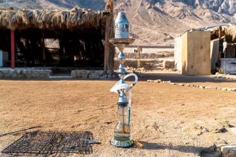 Hookah on shisha bowl ready to making clouds of steam at desert. Stock Photos