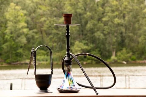 Hookah on the table against the background of nature and a river in Ukraine.. Stock Photos