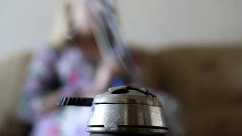 From the hookah there is a thin stream of smoke on the background of a girl Stock Footage 101201259