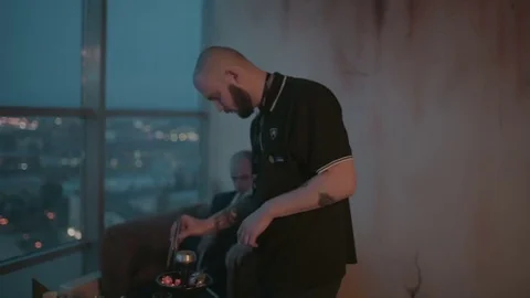 Hookahman changes the coals in the hookah close-up Stock Footage 76561523