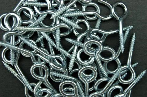 Hooked screw rings on a dark background. Stock Photos