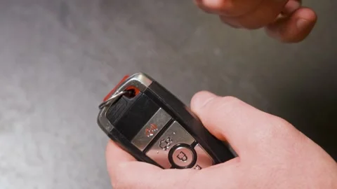 Hooking up a key fob onto a key chain. Stock Footage 342079272