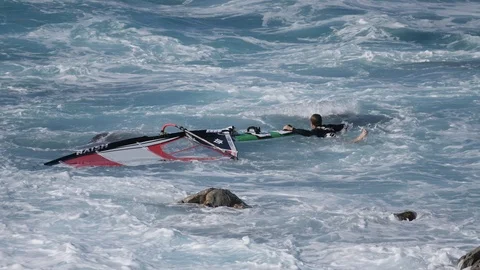 Hookipa Surf Windsurf conditions across da rocks full danger 4k slow motion Stock Footage 109396204