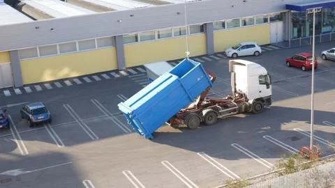 Hooklift truck loading a skip/container Stock Footage 252997567