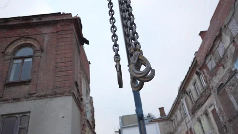 Hooks hang motionless against backdrop of fragile bricks Stock Footage 316077808