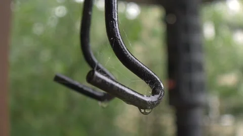 Hooks Hanging Outside In Calming Rain Storm Stock Footage 143161031