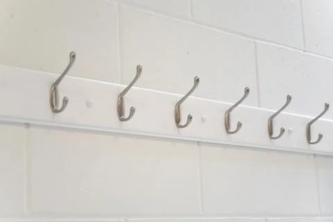 Hooks in a row on the wall Stock-Fotos
