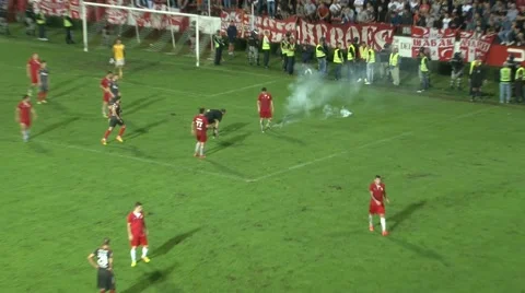 Hooligans throwing burning torch on playing field on soccer match game, zoom in. Stock Footage 41948369