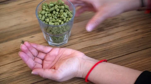 Hop Pellets Poured into hand Video stock 80208473