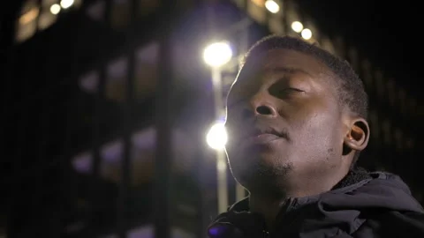 Hope, faith - young black man looks up closing his eyes as if praying Stock Footage 147286053