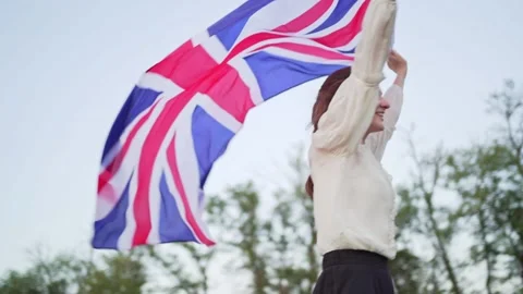Hope to get out of lockdown. British young female student with national flag Stock Footage 143157693