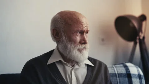 Hopeless elderly man crying alone at home, facing poverty and isolation Stock Footage 310008278