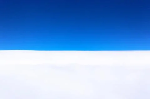 Horizon between a deep blue sky and clouds Stock Photos
