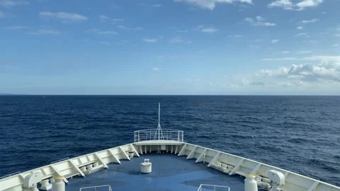 Horizon Bound: Ship's Bow Cutting Through Open Ocean with Clear Skies Stock Footage 247420937