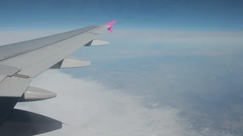 Horizon cannot be seen from plane window, clouds under airplane. Stock Footage 121244506
