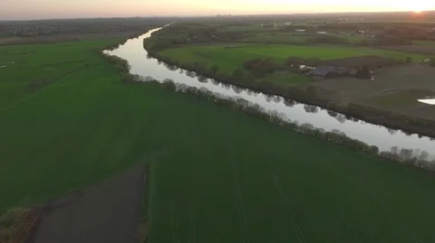 Horizon sunset over green fields in England a river reflection Stock Footage 88977741