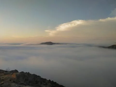 A horizon with white clouds on a peak Photos