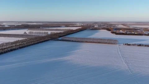 Horizontal 1080p Drone View Snowy Winter Fields and Distant Village in North Video stock 328201002