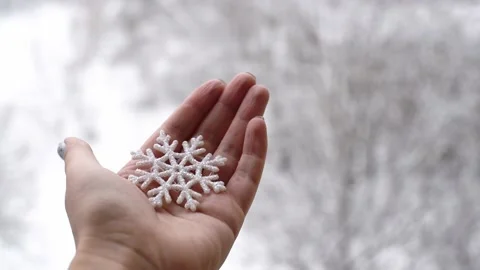 Horizontal 4k footage, close-up hand holds snowflake , winter time, snowy weathe Stock Footage 228258335