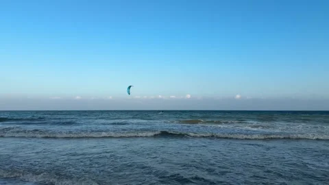 Horizontal 4K Long Shot of Kite Surfer on Sunny Hainan Beach Stock Footage 332037989