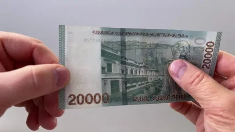 Horizontal 4K video close up. 60 fps. Male hand checking watermark on 20000 dram Stock Footage 329666932