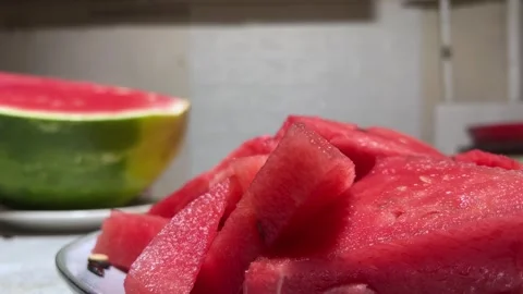 Horizontal 4K video close up. Man takes slice of watermelon from plate Stock Footage 280915250